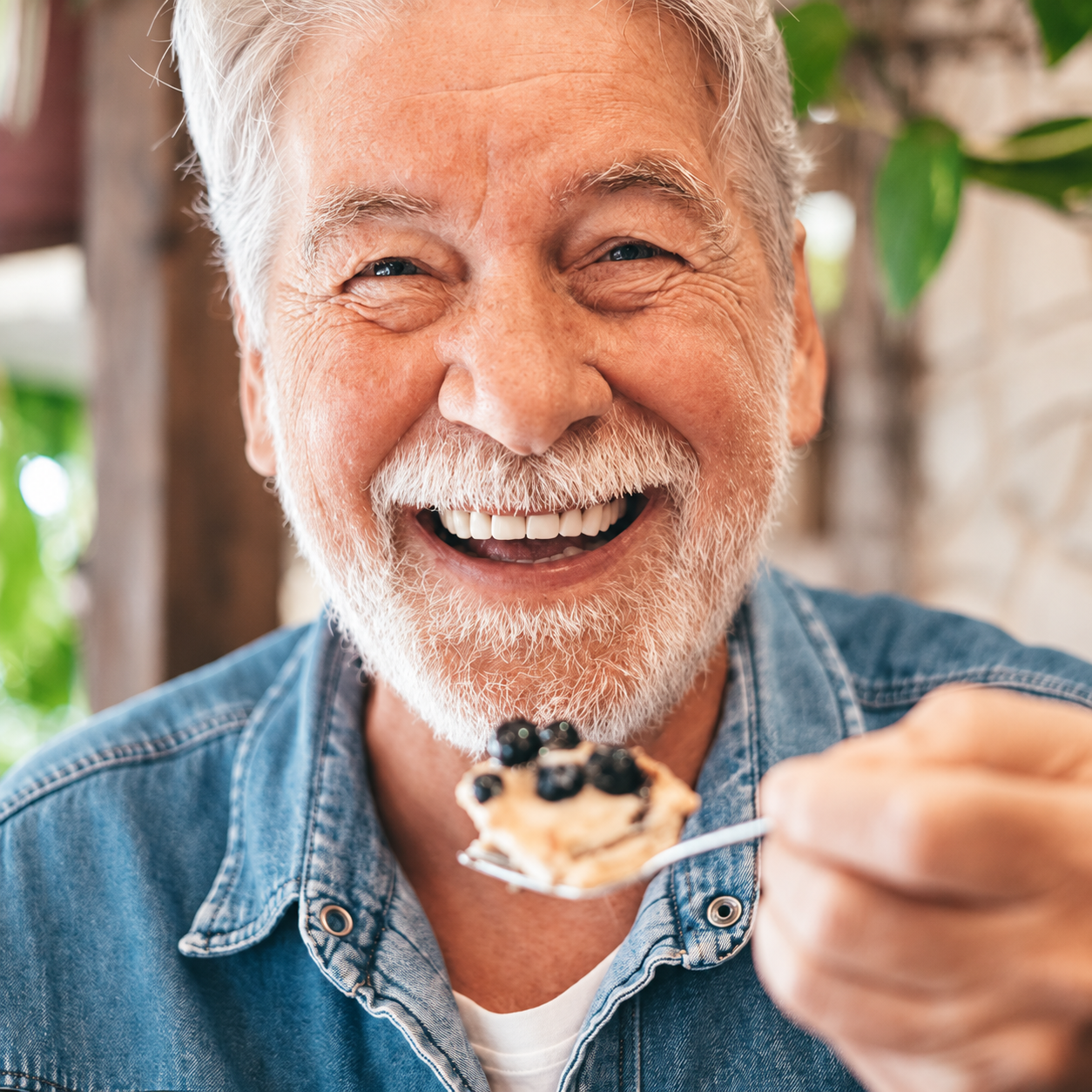 Older man enjoying a bite of food